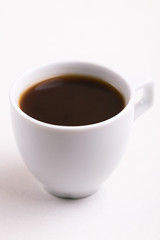 Cup of black strong coffee for breakfast on light background