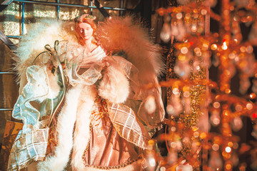 Christmas Angel wearing gold dress with white fur