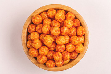 Full wooden bowl of bacon corn puff balls