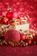 Christmas composition of Christmas tree toys on a blurred red background