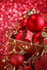 Christmas composition of Christmas tree toys on a blurred red background
