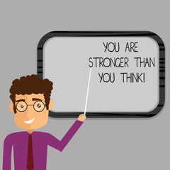 Writing note showing You Are Stronger Than You Think. Business photo showcasing Adaptability Strength to overcome obstacles Man Standing Holding Stick Pointing to Wall Mounted Blank Color Board