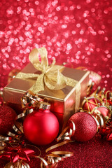 Christmas composition of Christmas tree toys on a blurred red background