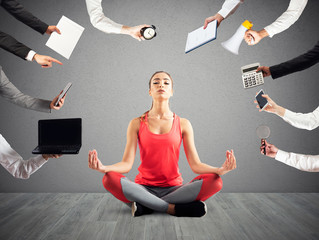 Woman tries to keep calm with yoga due to stress and overwork at wok - obrazy, fototapety, plakaty