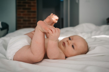 3 month old baby grabbing his feet