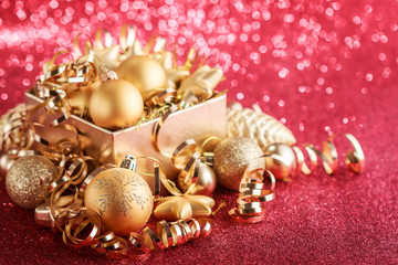 Christmas composition of Christmas tree toys on a blurred red background