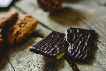 Black chocolate filled with mint cream on wooden background