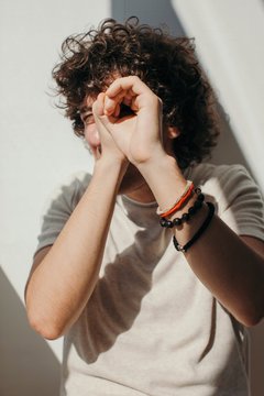Unrecognizable young curly man having fun at studio