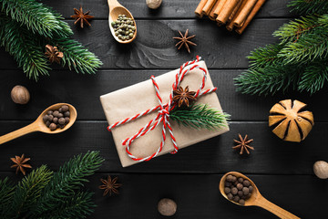 Vintage gift box with christmas decoration on dark wooden background.