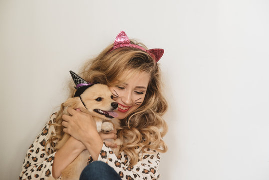 A teenage girl and her dog dressed up for halloween