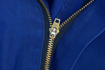 open yellow metal zip on blue clothes