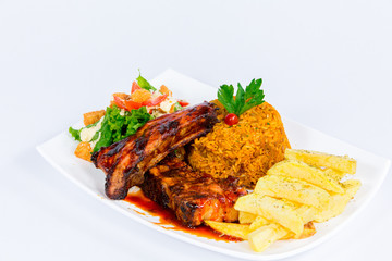 South American cuisine: rice with french fries, meat grill, salsa  and vegetable salad