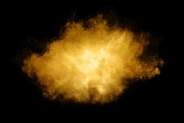 Fototapeta na wymiar Golden color Explosion. Glitter dust particles isolated on black background
