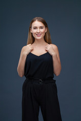 Fototapeta premium Beautiful blonde woman in black dress