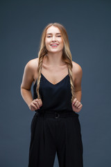 Fototapeta premium Beautiful blonde woman in black dress
