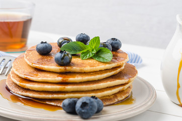 Stack of pancakes with fresh blueberry and caramel syrup