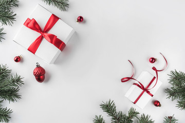 Christmas gift boxes on white background with Fir branches, pine cones, red ribbon. Xmas and Happy...
