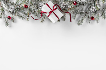 Christmas gift boxes on white background with Fir branches, pine cones, red ribbon. Xmas and Happy New Year theme. Flat lay, top view