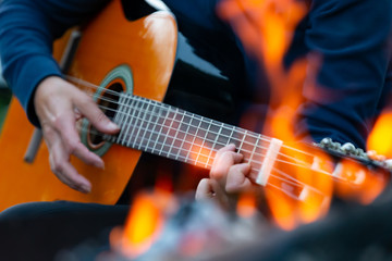 guitar music player at wild camp fire