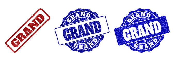 GRAND scratched stamp seals in red and blue colors. Vector GRAND labels with grainy texture. Graphic elements are rounded rectangles, rosettes, circles and text labels.