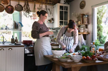Crédence de cuisine en verre imprimé Cuisinier Two women cooking in the kitchen