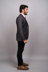Profile view of Indian businessman against gray background