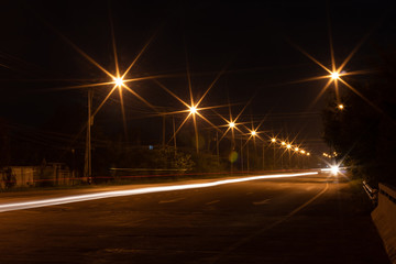 Lights, lanterns, and car headlights on twilight.