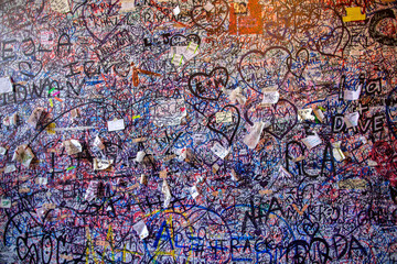 Graffiti on the brick vole Juliet's house in Verona. Wall covered with love messages, Juliet's House, Verona, Italy.