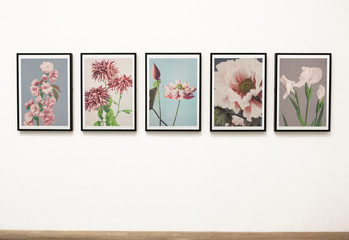 Obraz premium Collection of floral art pieces on a wall