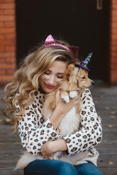 A teenage girl and her dog dressed up for halloween