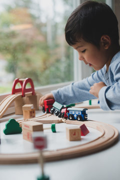 Little kid playing with train set