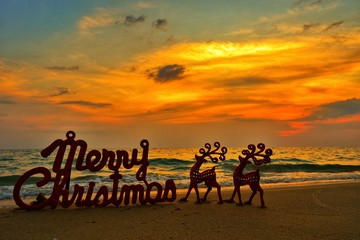 Happy new year concept, Merry Christmas put no sand beach in sunset.