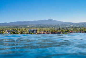 Town view from ocean with mountains in background