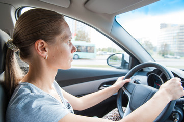 Naklejka premium one white blond attractive young woman drives a car