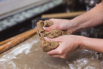 Woman makes christmas gingerbread cookies on black and red background
