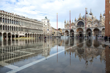 Fototapeta premium Venice, Italy - November 27, 2018: High water on St. Mark's Square in Venice. St. Marks Square (Piazza San Marco) during flood (acqua alta) in Venice, Italy