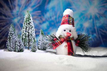 festive background. snowman dressed as Santa Claus with Christmas balls on light background photo has an empty space for your text