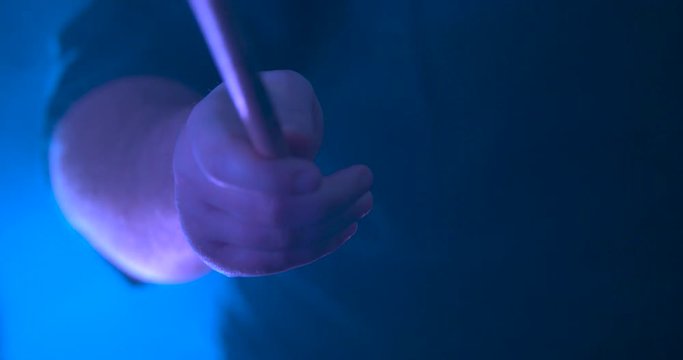 Closeup of a Drummers Hand and Drumstick as They Play in Slow-Motion