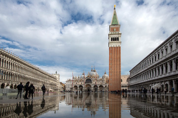 Naklejka premium Venice, Italy - November 27, 2018: High water on St. Mark's Square in Venice. St. Marks Square (Piazza San Marco) during flood (acqua alta) in Venice, Italy. St. Mark's Basilica