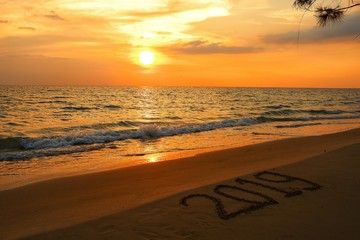 Fototapeta na wymiar Happy new year concept, 2019 put on sand beach in sunset.