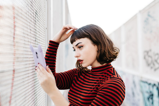 Woman adjusting her bangs