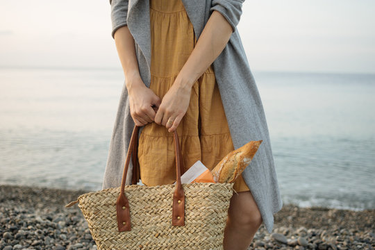Unidentified person holding shopping bag with baget