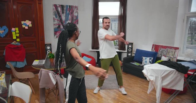 Young couple freelancers doing exercises at home during breaks from work