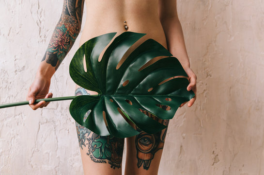  tattooed young woman with palm leaf