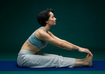 Pretty woman doing yoga exercise