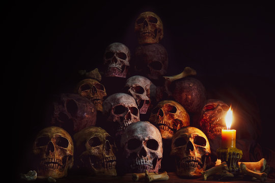 Pile of Skulls and bones Lighting by candlelight / Still Life Image and dim light and adjustment color for background