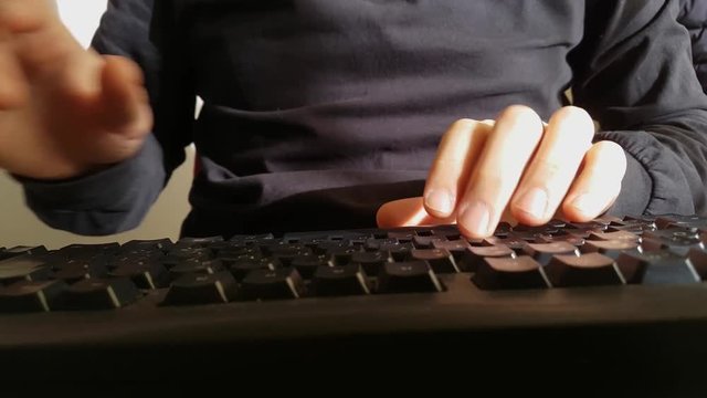 a man type the keys of a computer keyboard