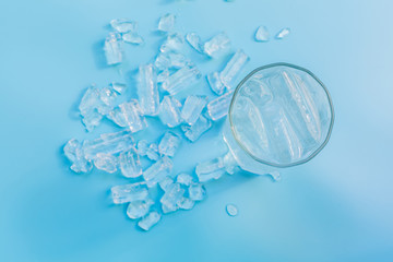 Top view glass of water with ice on blue background, glass of water.