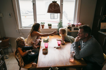 Real family dinner with mom, baby, busy kids and normal food