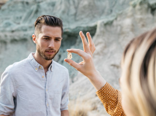 Young adult female shows male friend a crystal rock 
